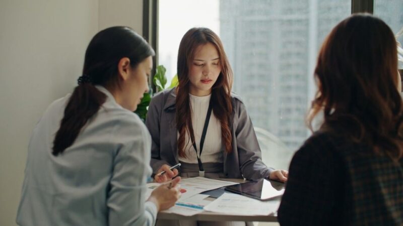 HR razgovor u kancelariji gde se kandidat i tim sastaju za stolom i razmatraju dokumentaciju